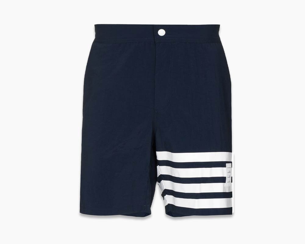 Thom Browne swim shorts in dark blue with white stripes on left leg