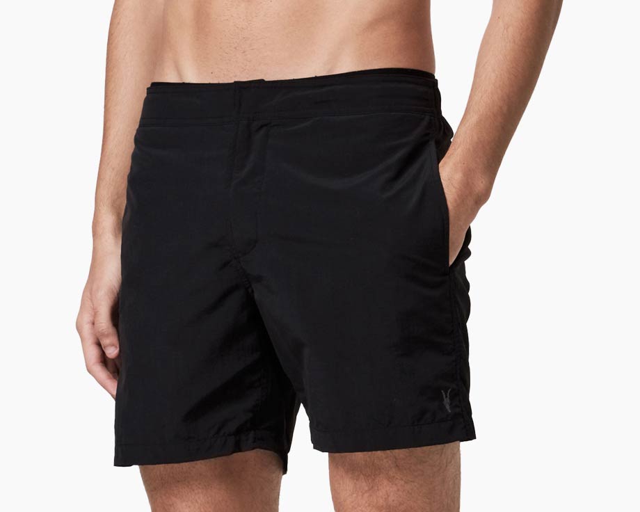 Man wearing AllSaints swim shorts in all black