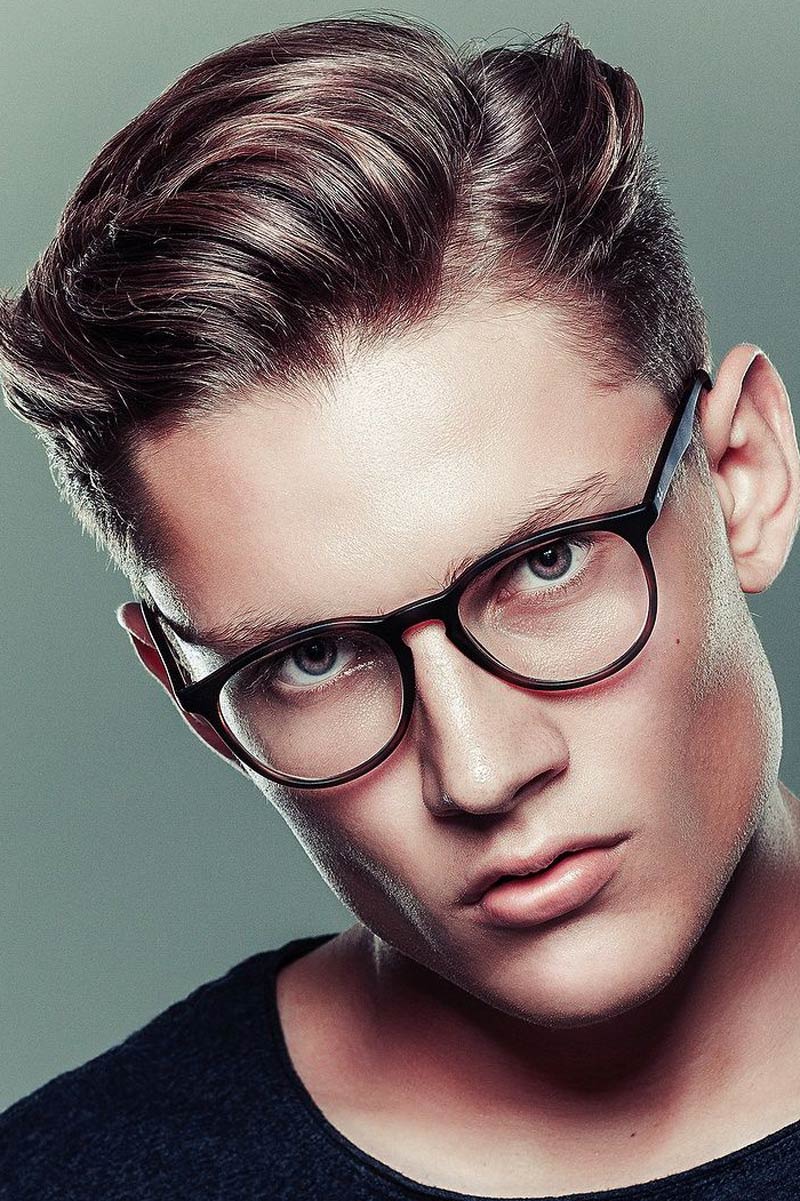Man wearing glasses with side-part haircut.