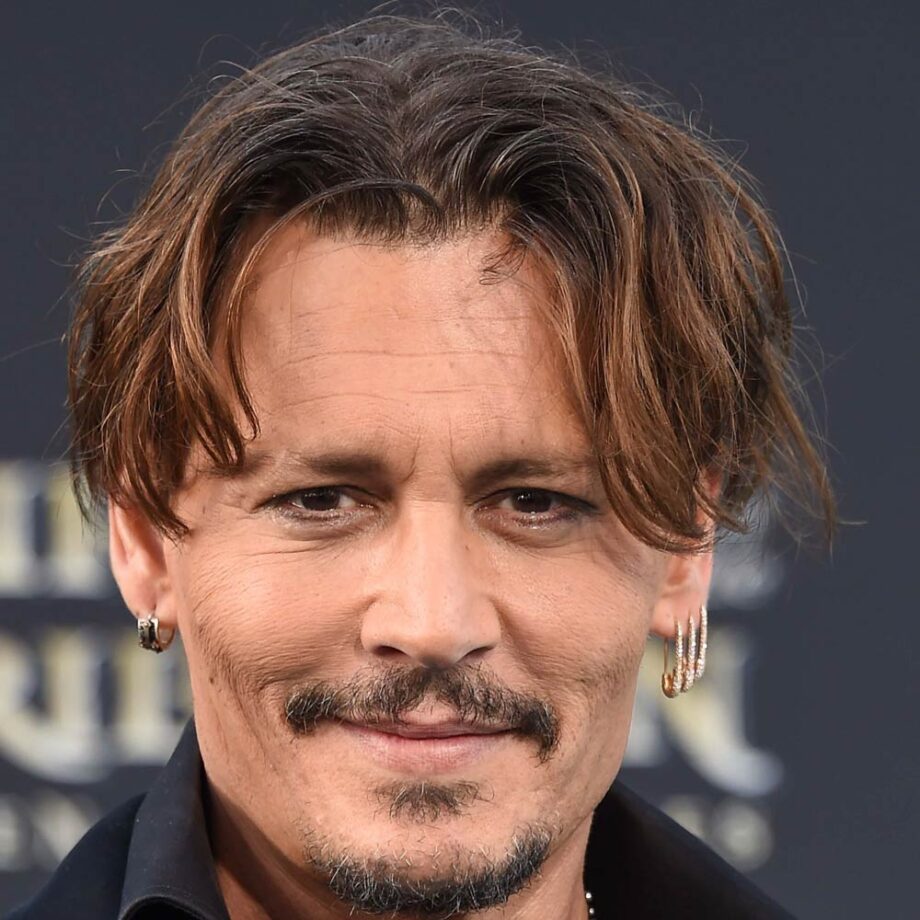 Johnny Depp with short-length curtains hairstyle. 