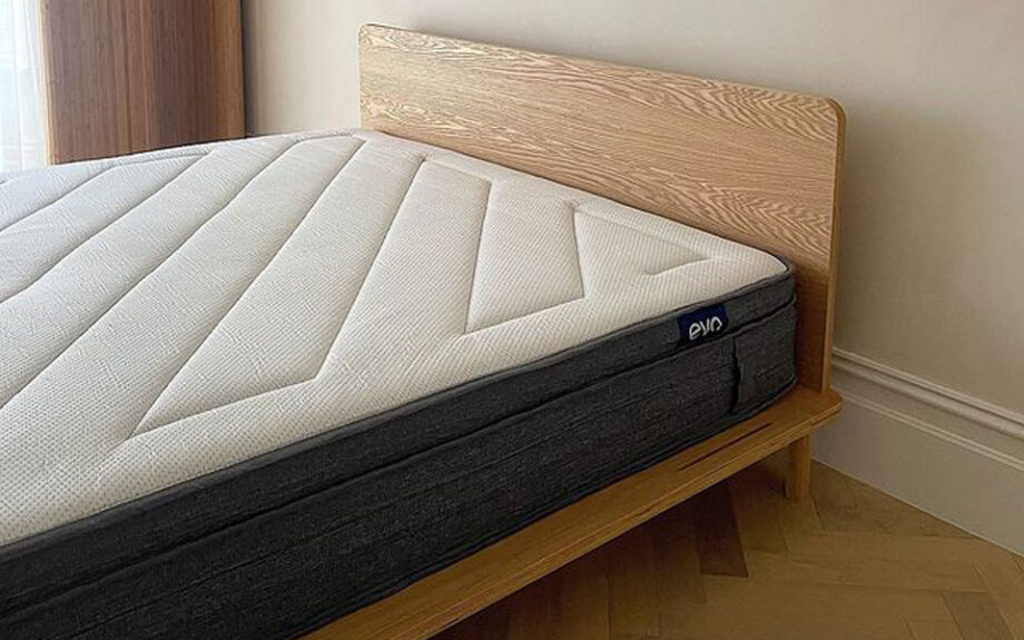 Eva mattress with no sheet on, laying on timber bed frame