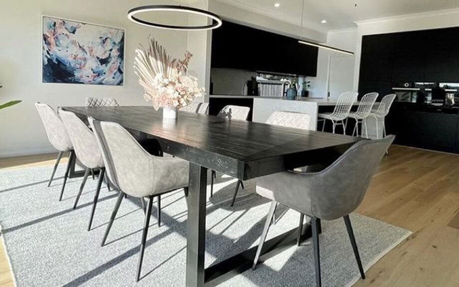 Black Vorsen dining room table with grey upholstered chairs