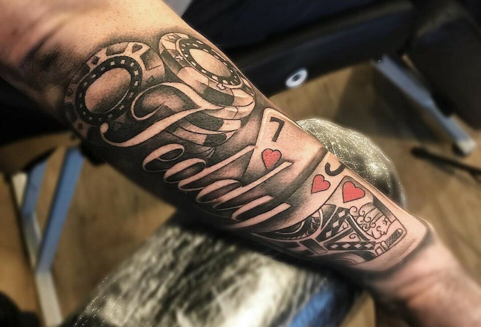 Playing card forearm tattoo