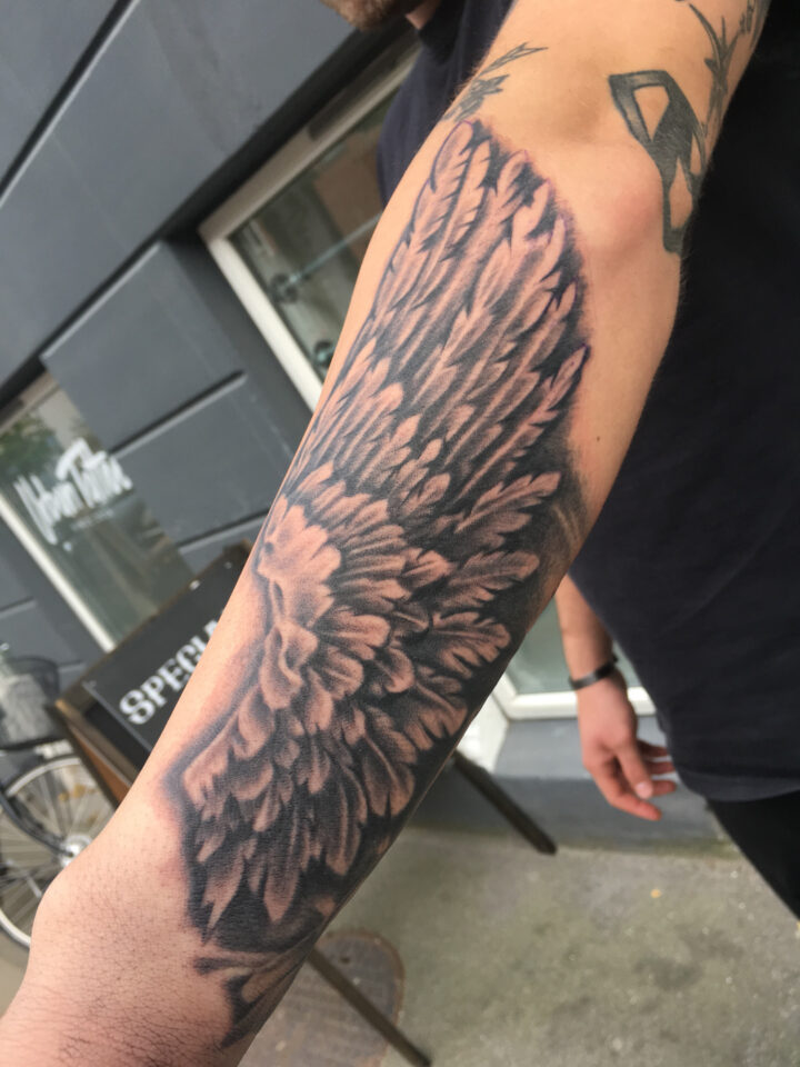 Wings forearm tattoo