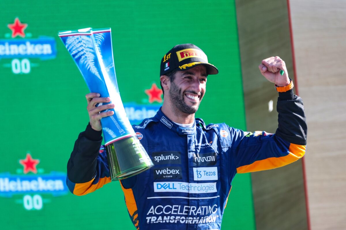 Daniel Ricciardo holding a trophy.