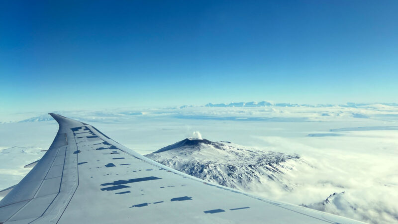 View out of an aeroplane window looking at Mount Erebus in Antarctica