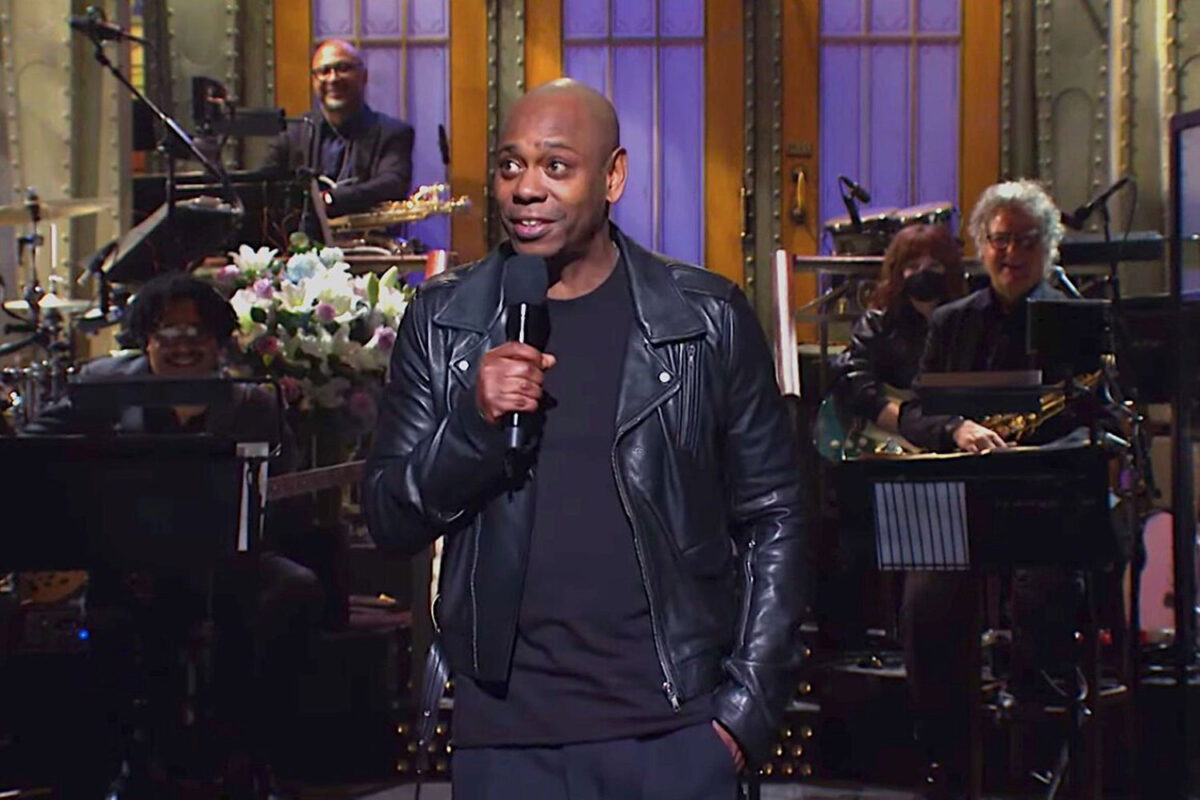 Comedian Dave Chappelle holding a microphone whilst performing a monologue at Saturday Night Live