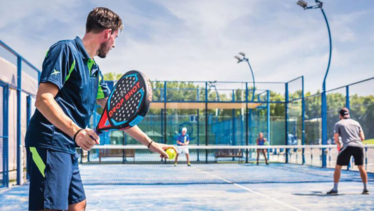 Image of a padel player about the serve a padel ball