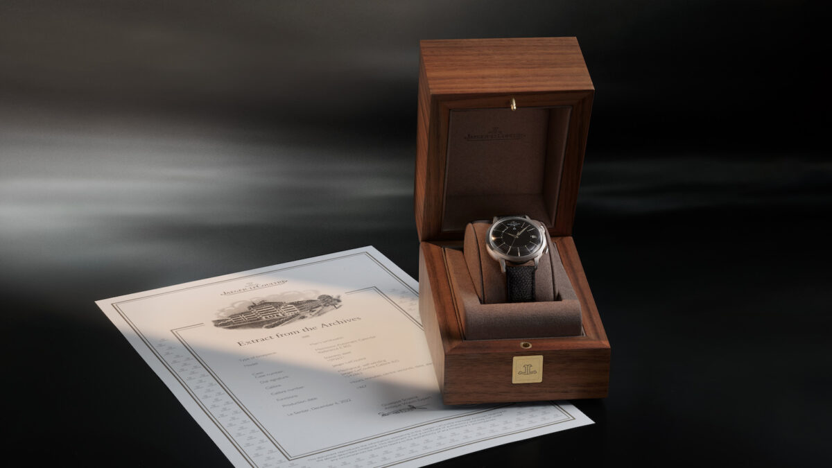 A vintage Jaeger-LeCoultre in a wooden box with an 'extract from the archives'.