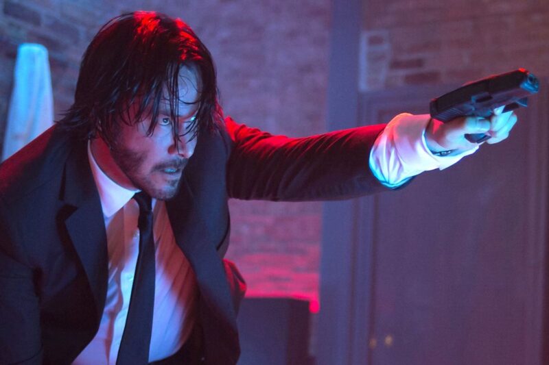 Keanu Reeves points a gun during a fight scene in John Wick 2.