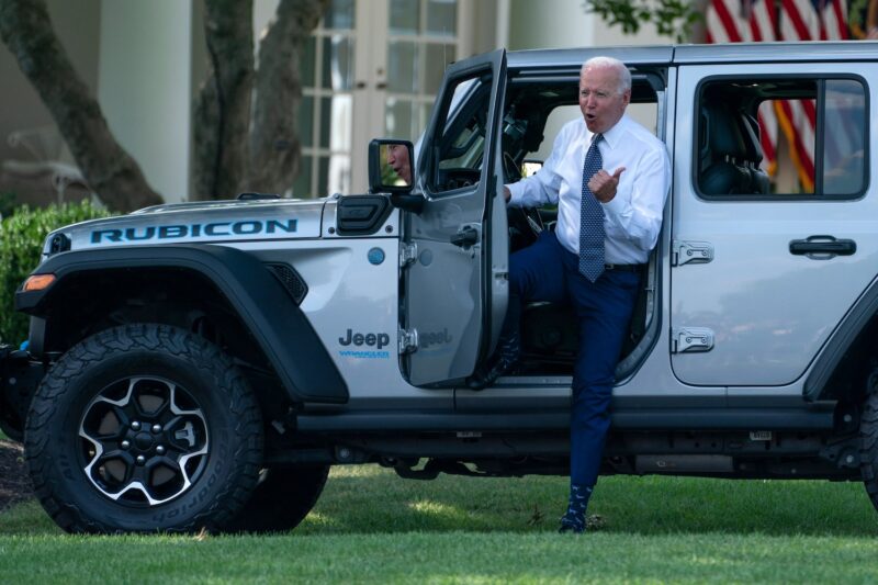 Joe Biden gets out of a Jeep.