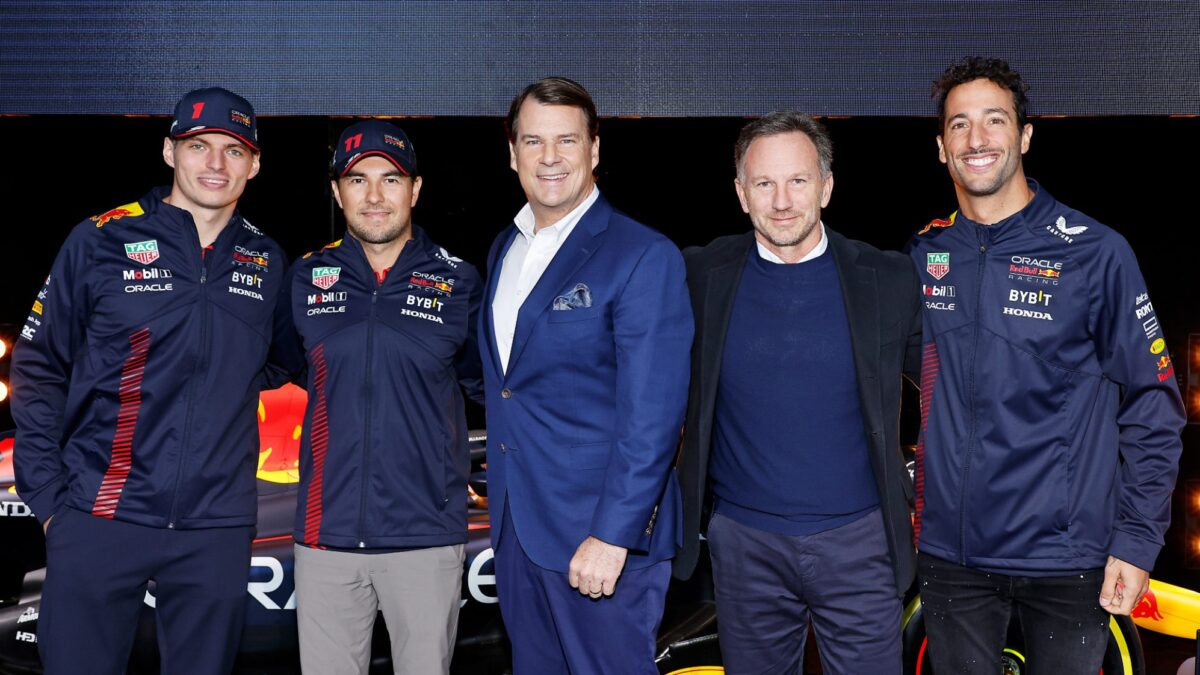 Ford CEO Jim Farley poses with Red Bull's Max Verstappen, Sergio Pérez, Christian Horner and Daniel Ricciardo.