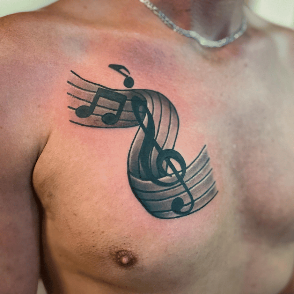 Music Notes Chest Tattoo Source @mainstreettattoo13 via Facebook