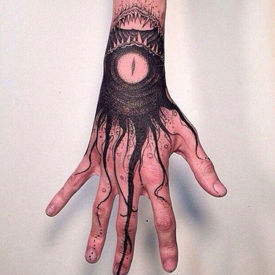 sea monster hand tattoo