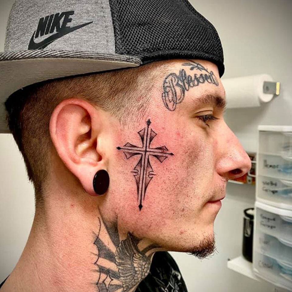 Face Cross Tattoo Source @badseed_tattoo_llc via Instagram