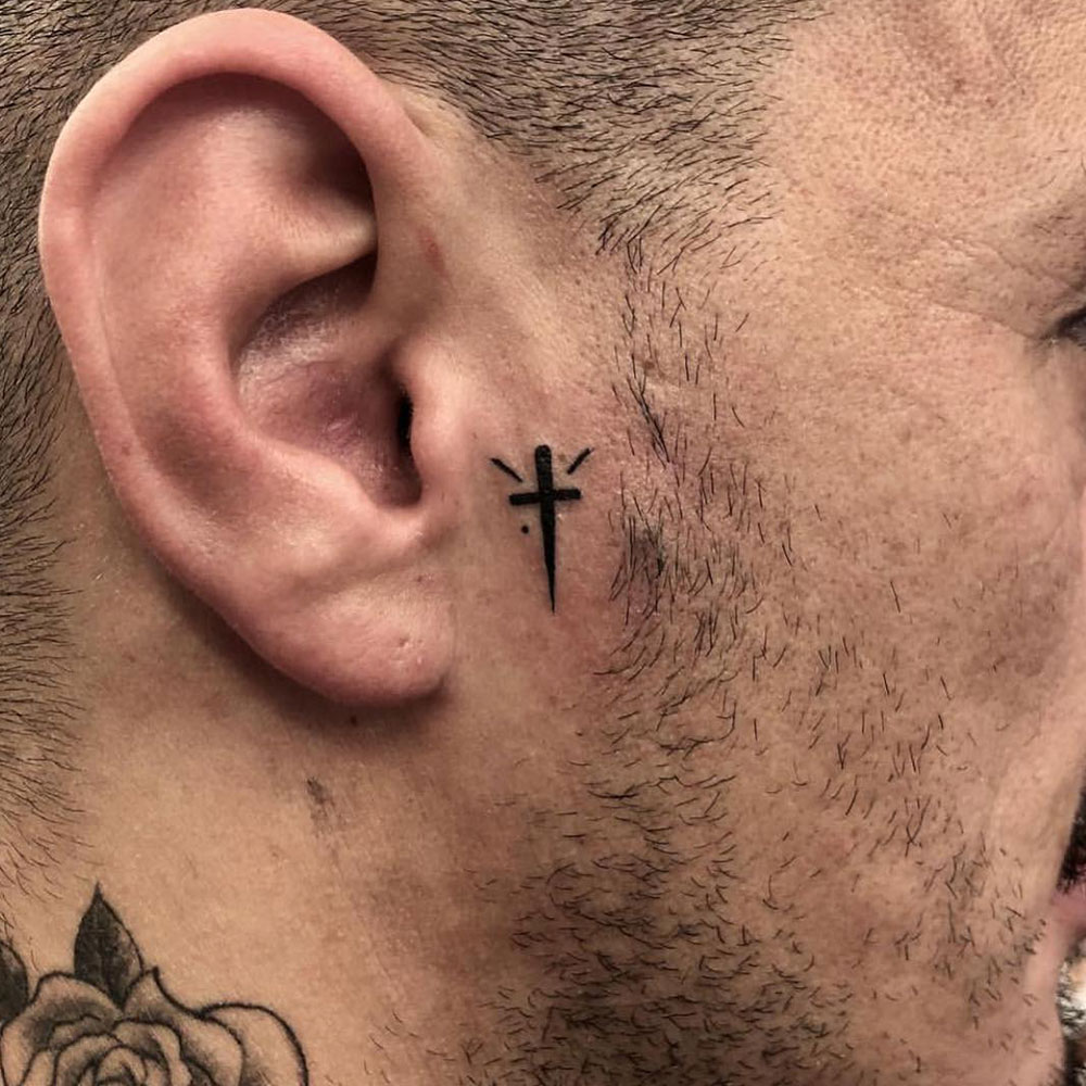 Face Cross Tattoo Source @sinsintattoo via Instagram