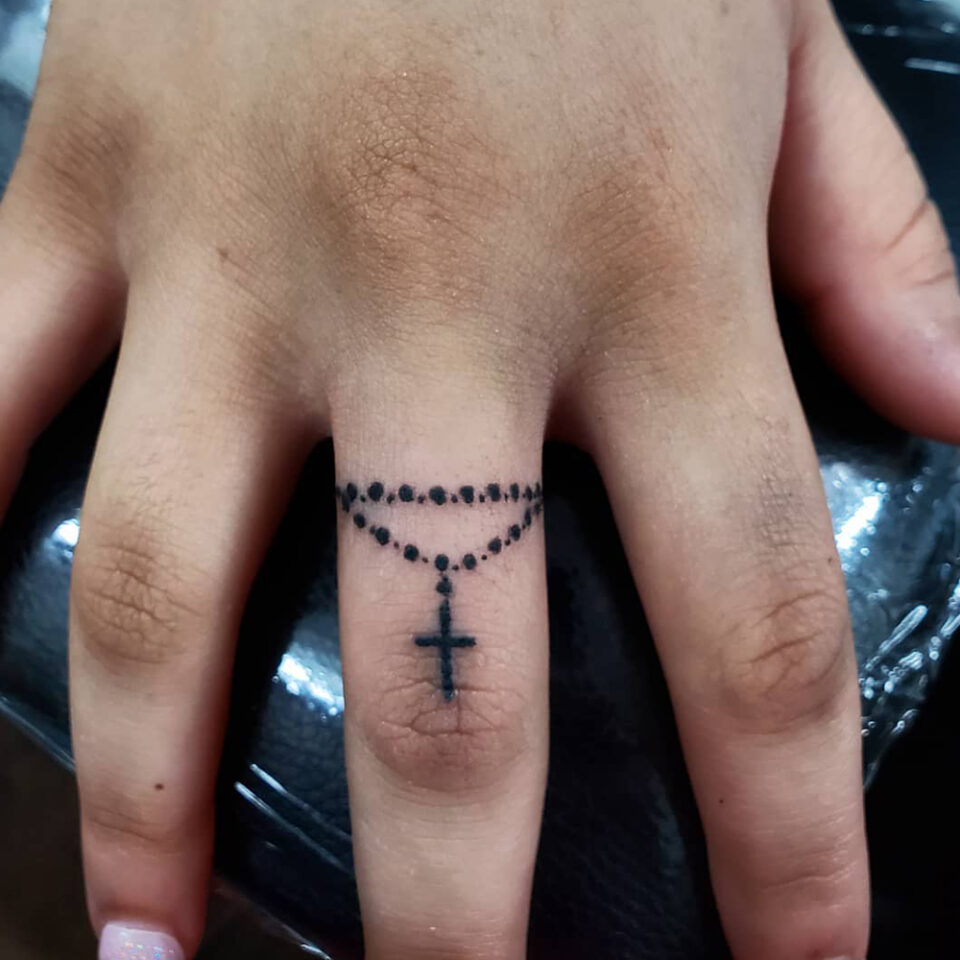 Finger Cross Tattoo Source @byraminktattoo via Instagram
