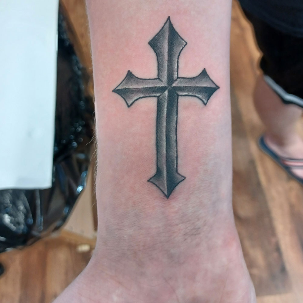 Attractive Grey Ink Winged Cross Tattoo On Left Shoulder