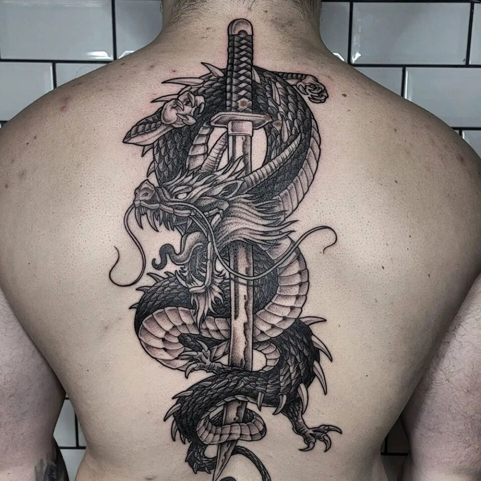 Dragon sword tattoo Source @tommygtn_tattoo via Instagram