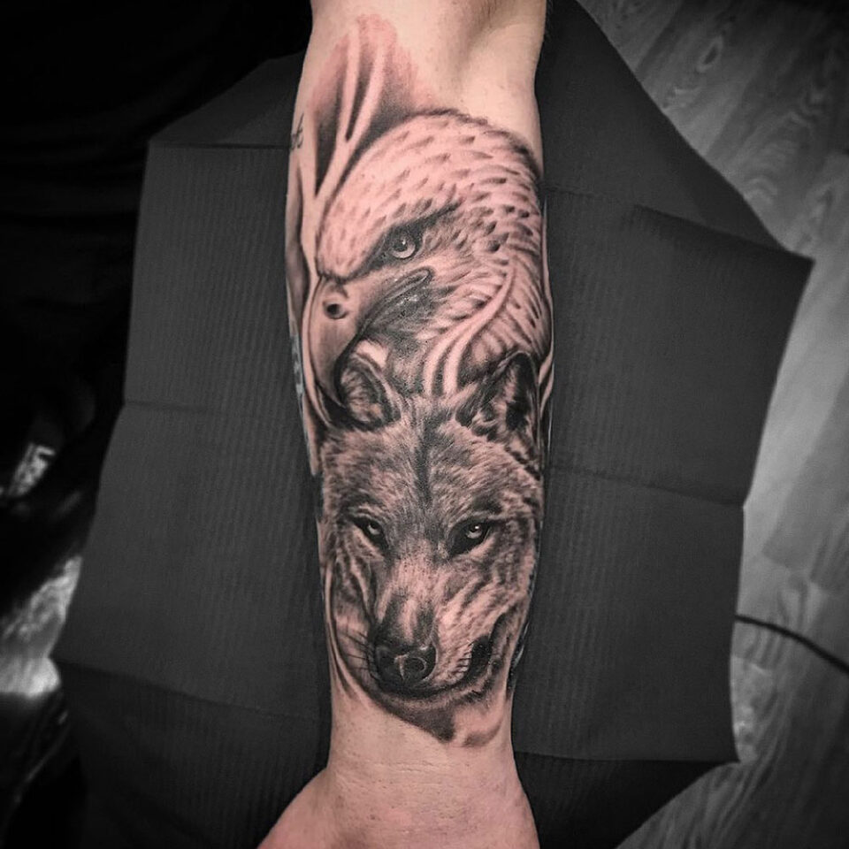 Eagle and wolf tattoo Source @danwtattoos via Instagram