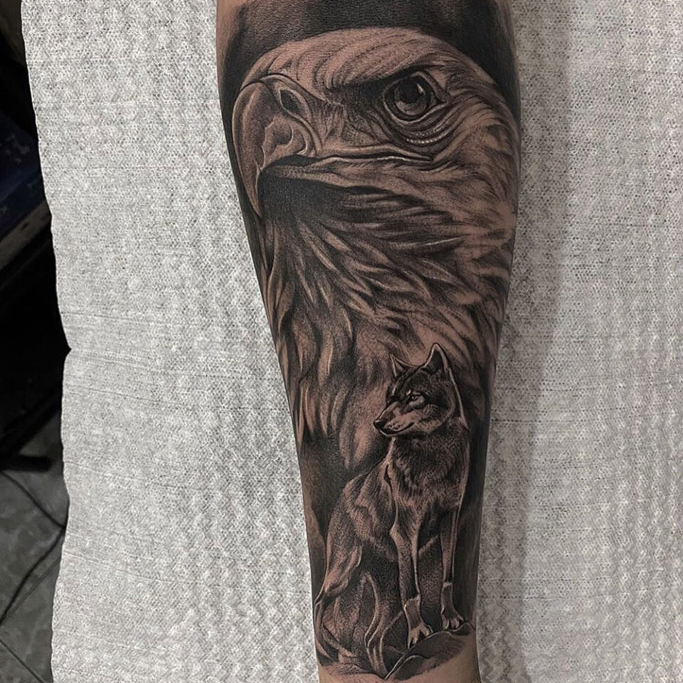 Eagle and wolf tattoo Source @juansetattoos via Instagram