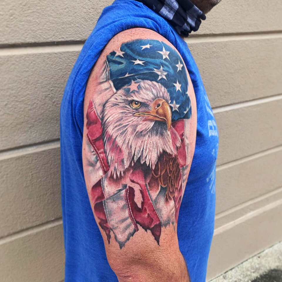 Eagle tattoo with a Patriotic flag Source Folklore Tattoo Company via Facebook