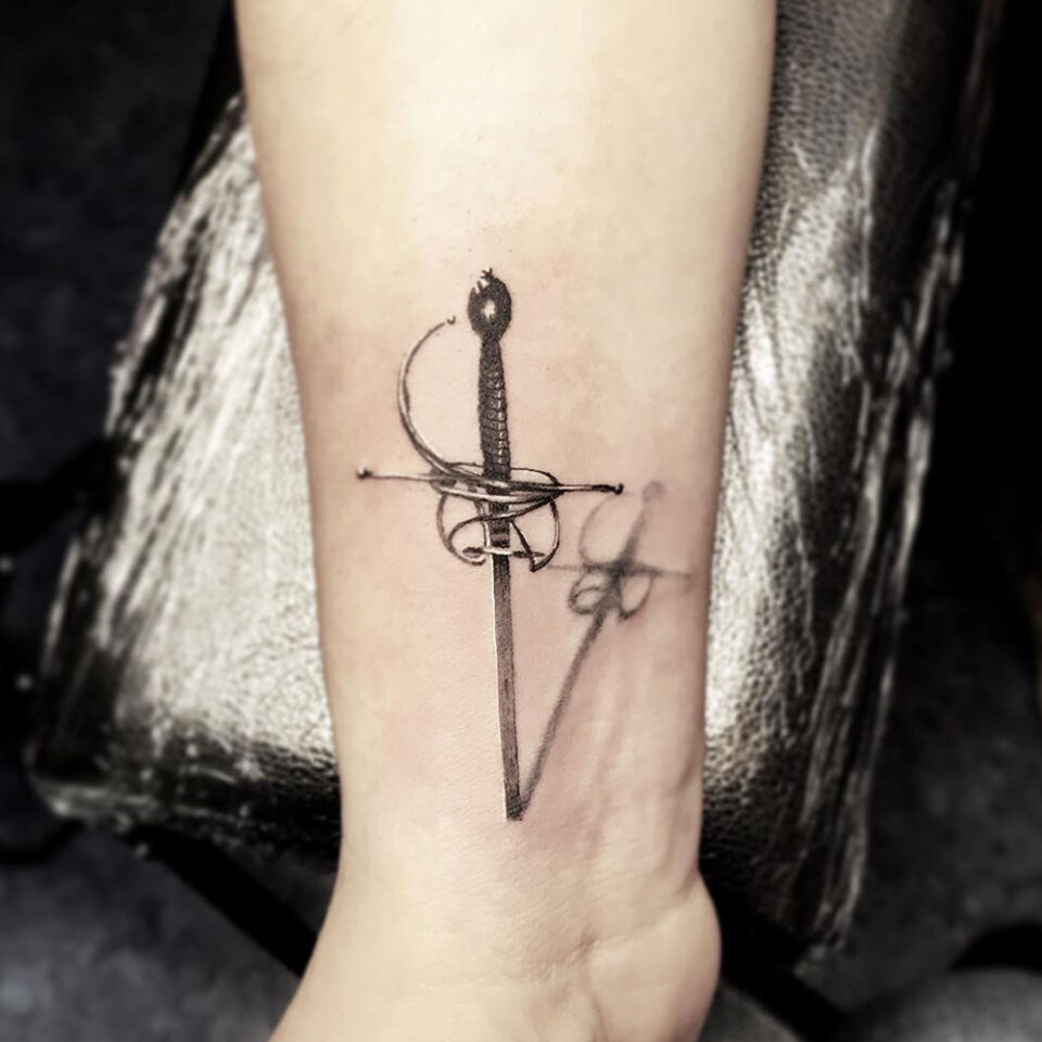Fencing sword tattoo Source @killerinktattoo via Instagram