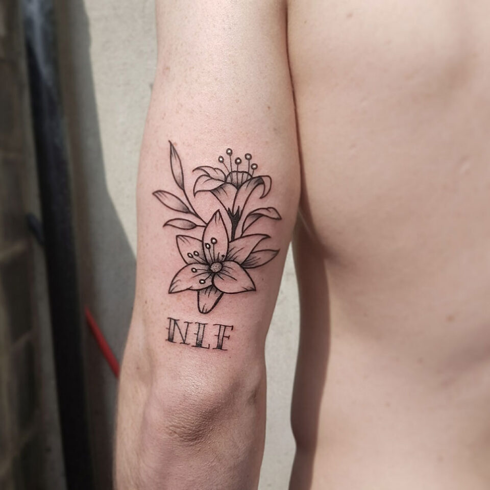 Lily floral tattoo sourced via IG @adamwhelans