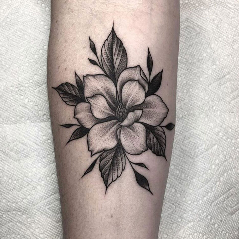 Magnolia floral tattoo sourced via IG @devxruiz