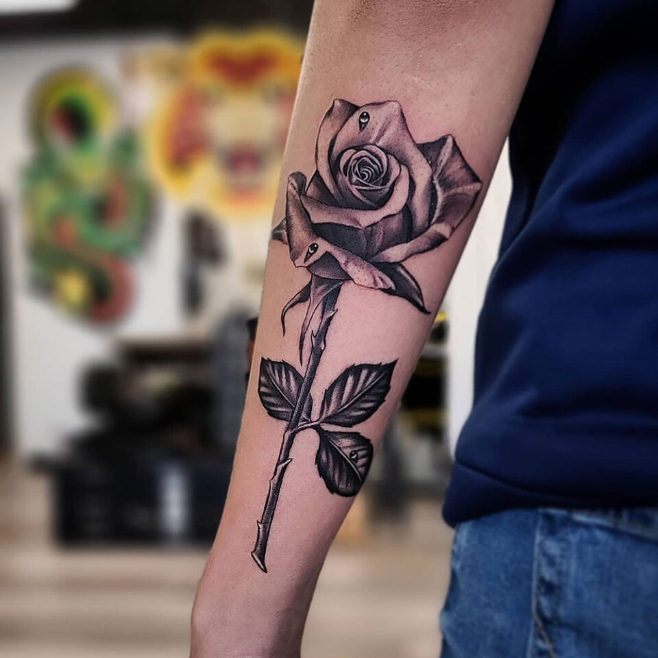 Rose with Thorns floral tattoo sourced via IG @tigerrosetattooog