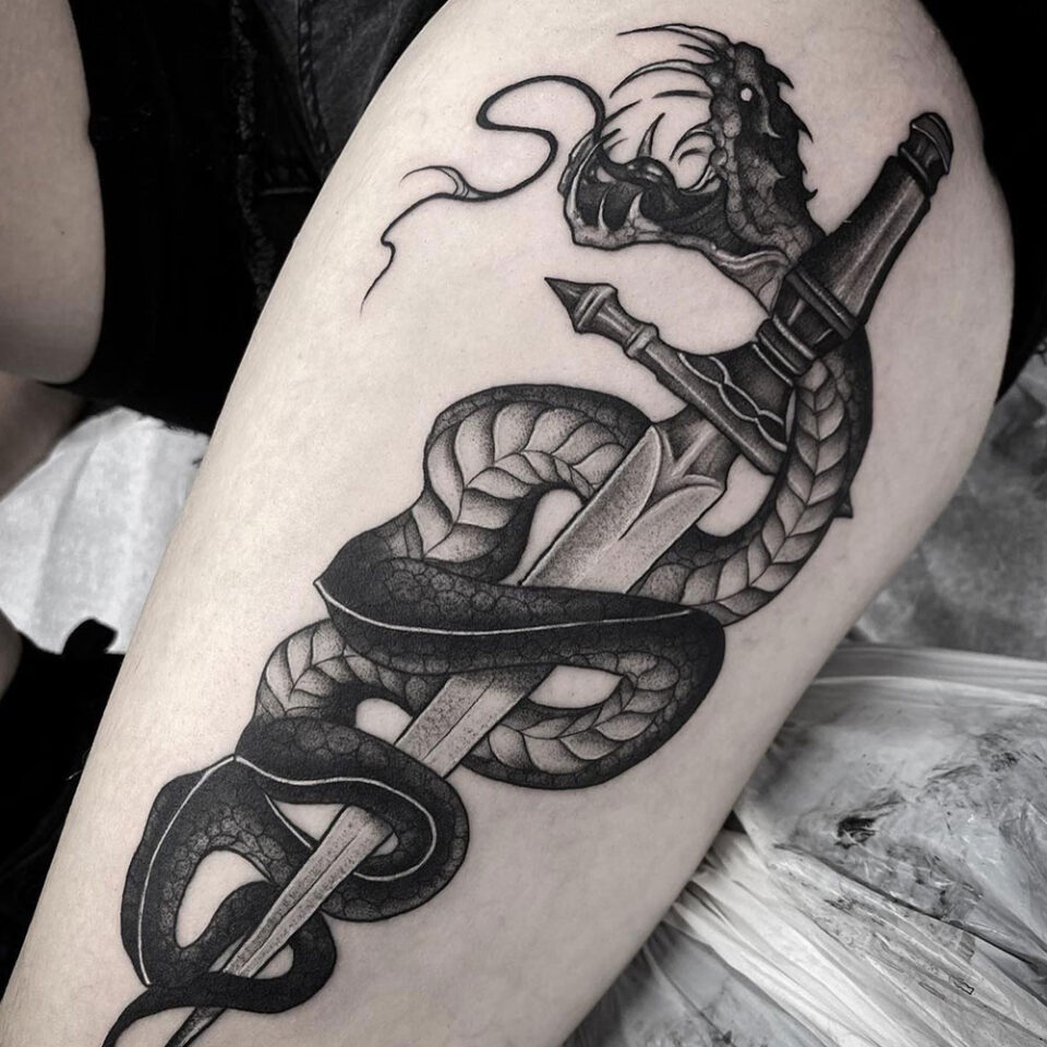Serpent sword tattoo Source @ludo_mortuus via Instagram