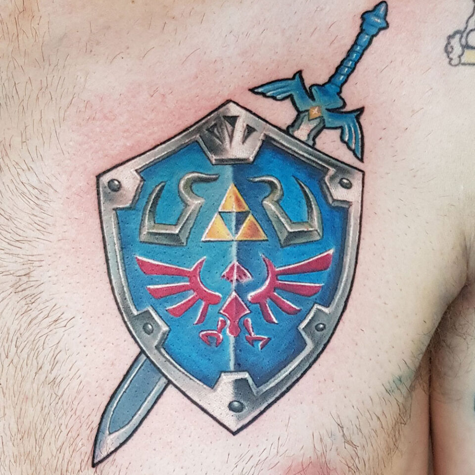 Shield with sword tattoo Source @elementaltattoostudioswindon via Instagram