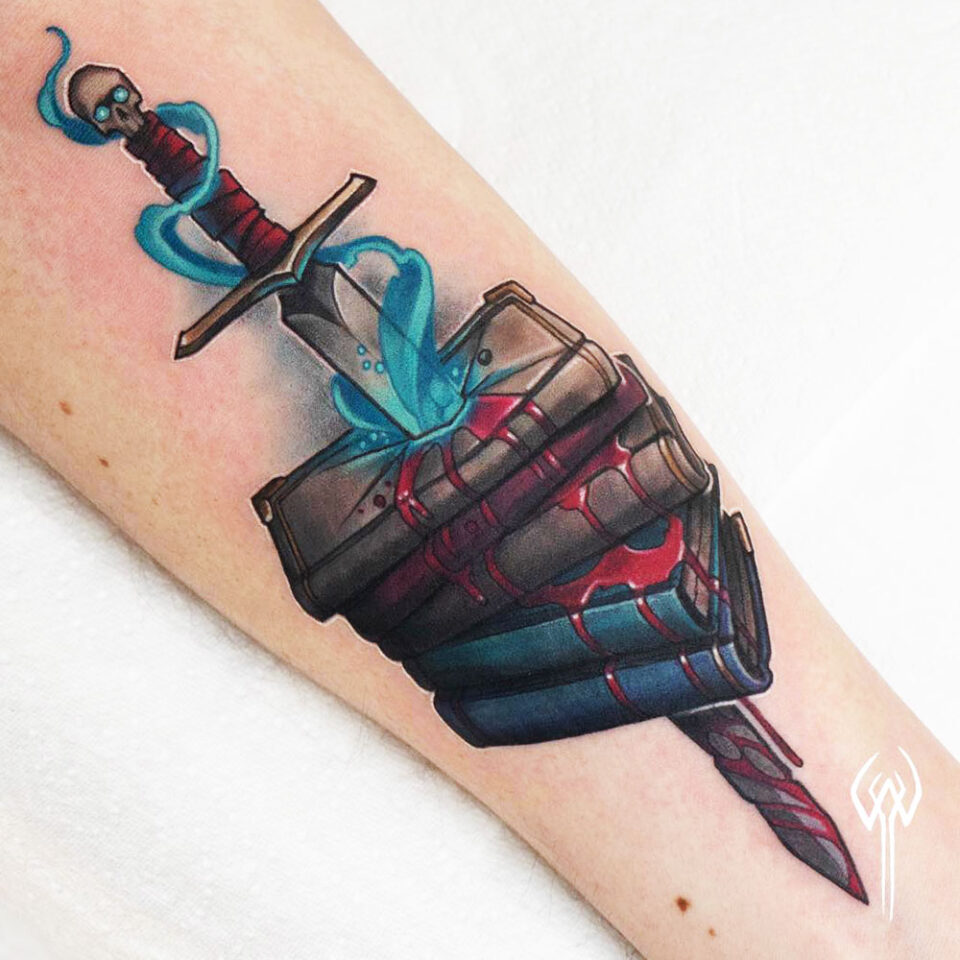 Sword piercing through a book tattoo Source @awhite.tattoo via Instagram