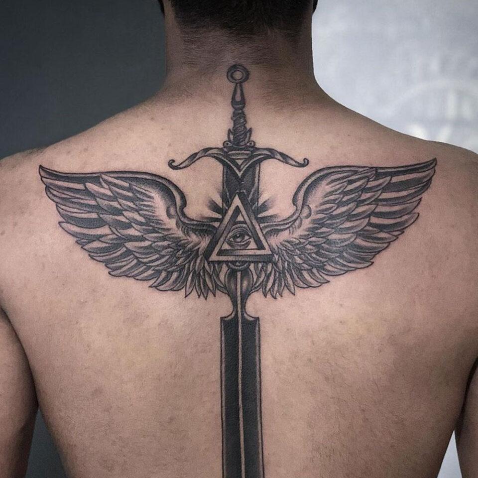 Sword with wings tattoo Source @inkblottattooz via Instagram