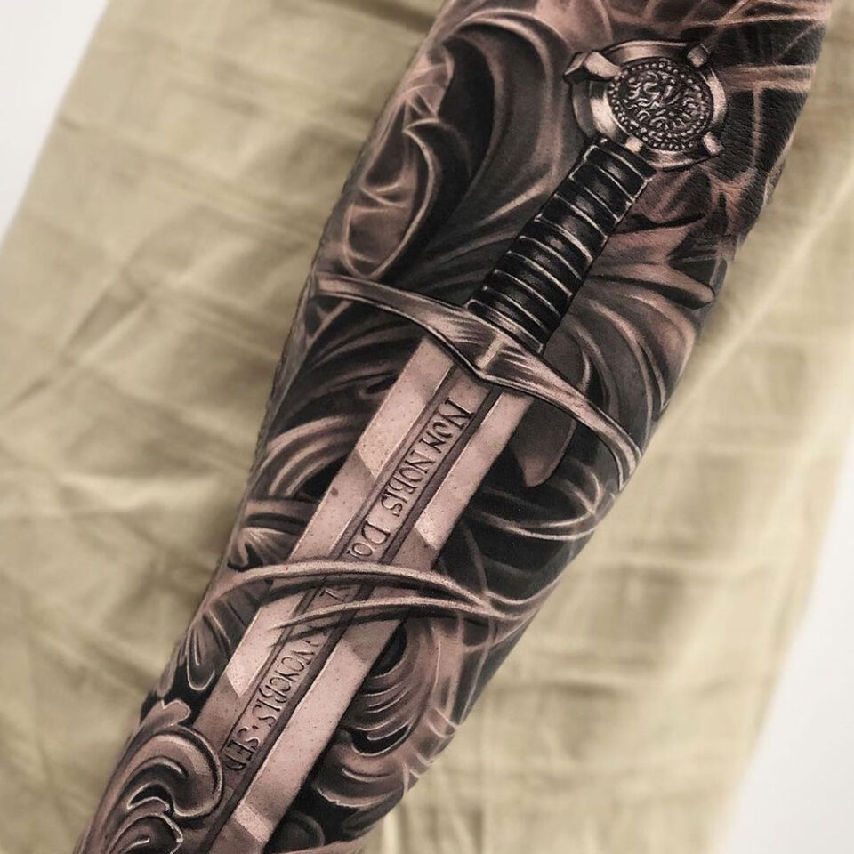 On the inside of a forearm, there is a long broken sword with three small  blue roses and vines. tattoo idea | TattoosAI