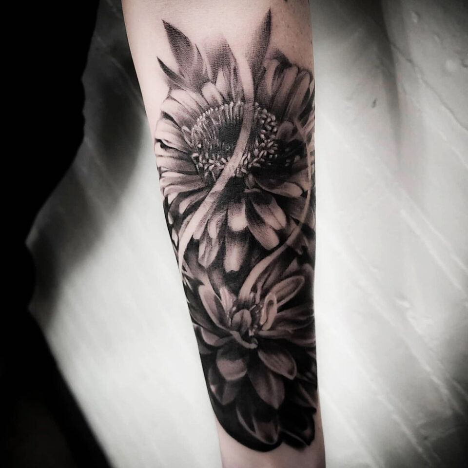 Zinnia floral tattoo sourced via IG @_mark_skipper_tattoos_