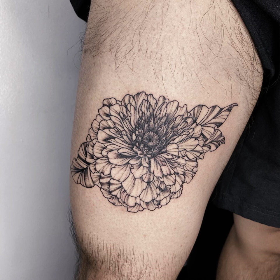 Zinnia floral tattoo sourced via IG @theuncannie