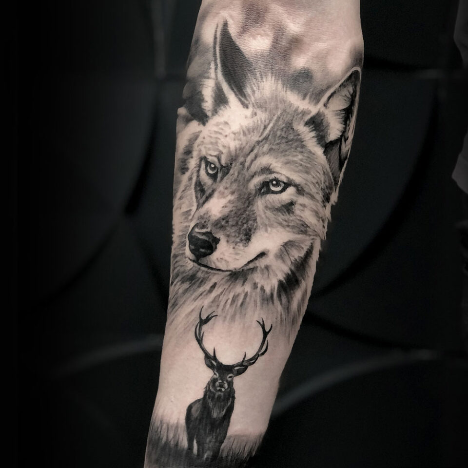 wolf and deer tattoo Source @feinkunsttattoo via Instagram