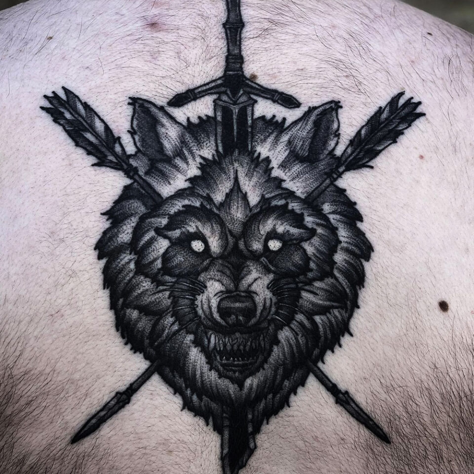 wolf and sword tattoo Source @_johnhastie_ via Instagram