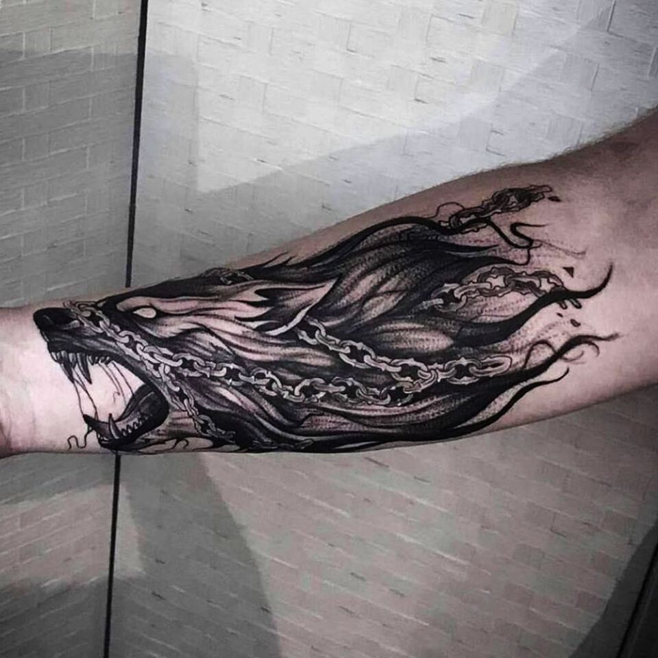 wolf in chain tattoo Source @ashryantattoo via Instagram