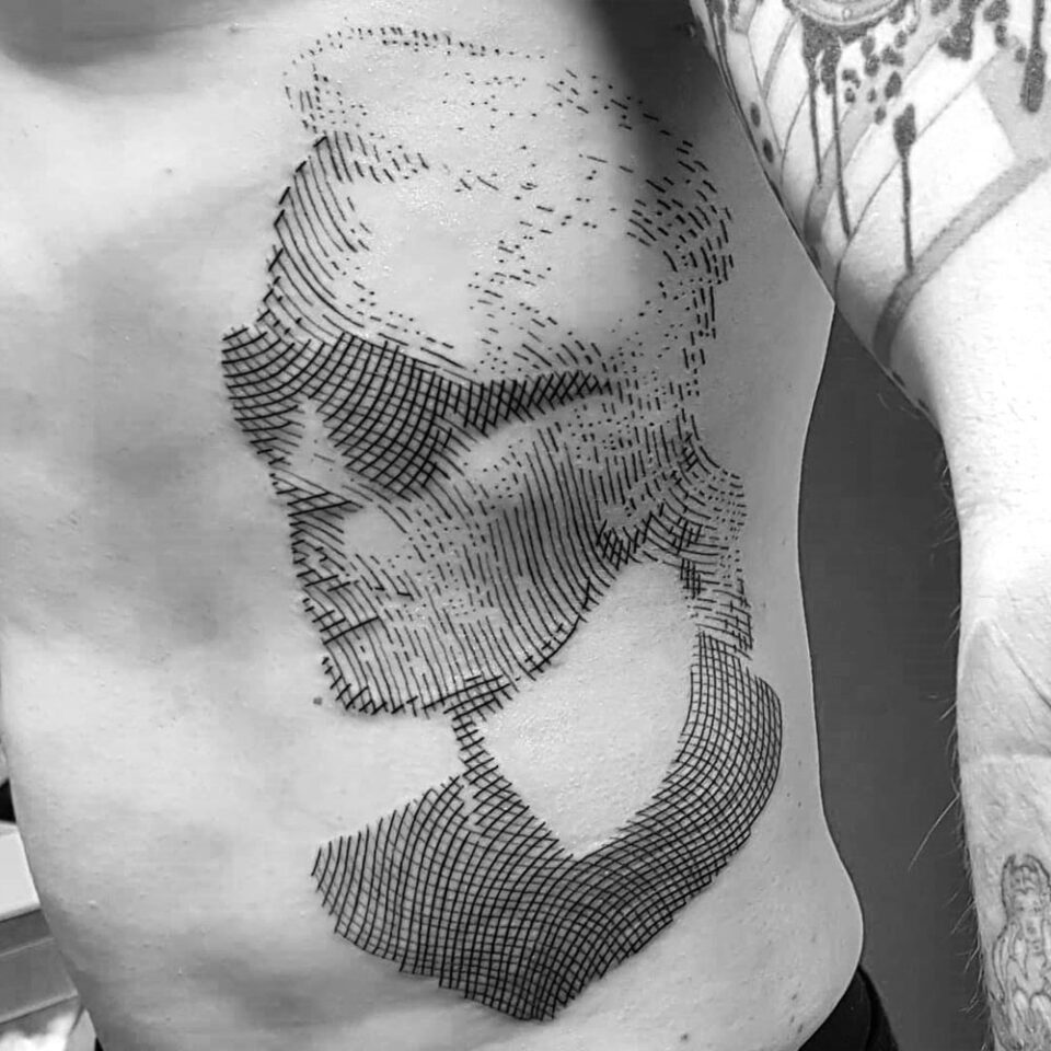 Iconic Fashion Designer Portrait Tattoo Source @optikart_tattoo via Instagram