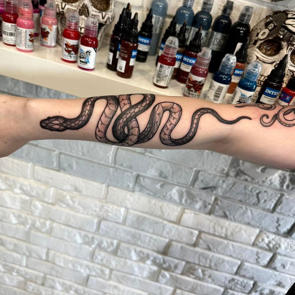 Snake Coiling up the Forearm Pet Tattoo Source @goat.tattoo_warszawa via Instagram