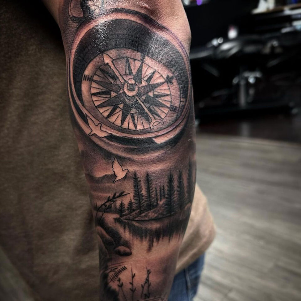 compass with mountain landscape tattoo Source @smileyinktattoos via Instagram