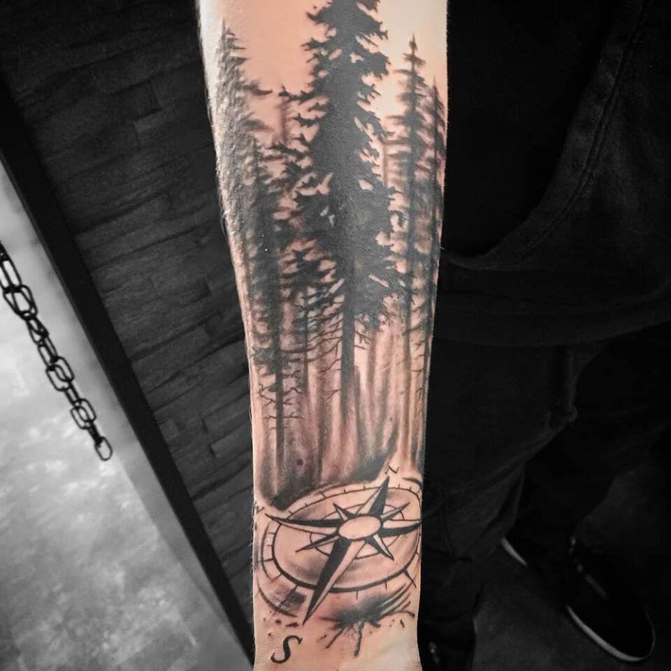 compass with forest silhouette tattoo Source Tattoos by Tina via Facebook