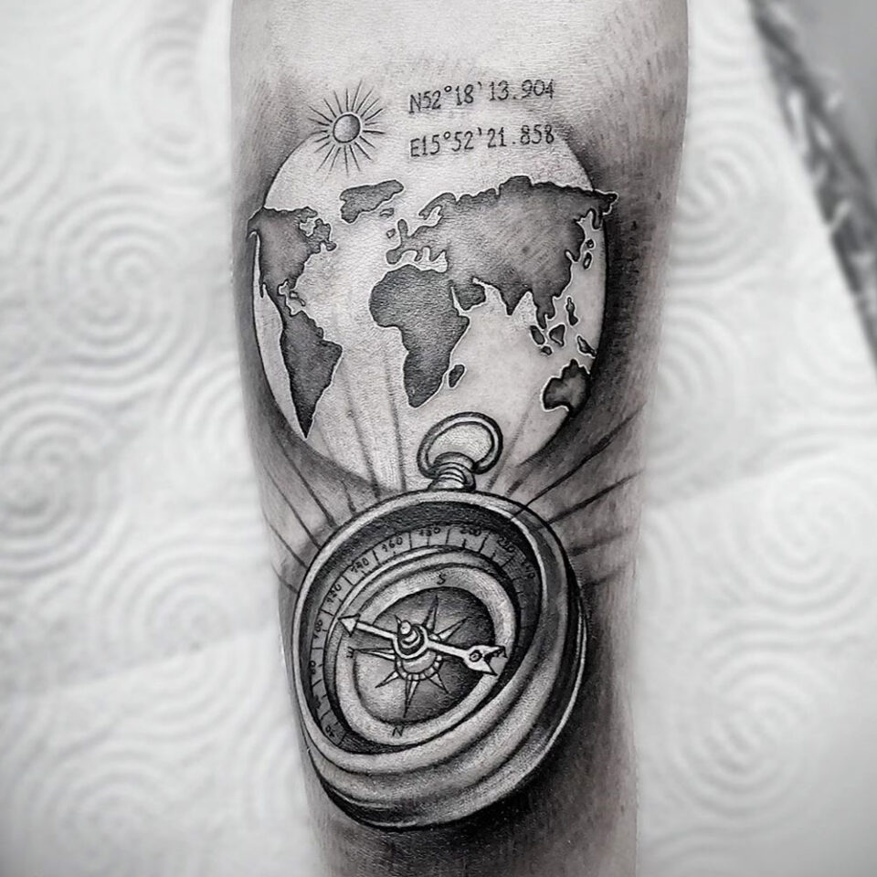 compass with globe tattoo Source @dotattookarolina via Instagram