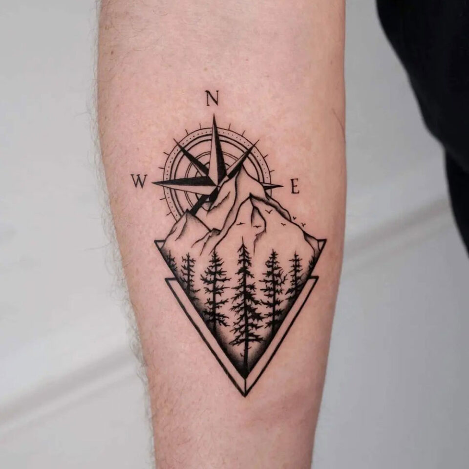 compass with mountain landscape tattoo Source @tattoolexis via Instagram