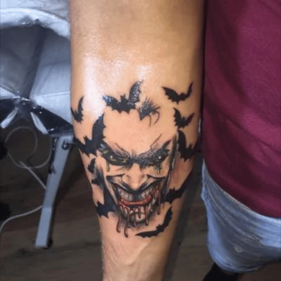 Joker's Smile With Blood Splatter Source tattoodo.com