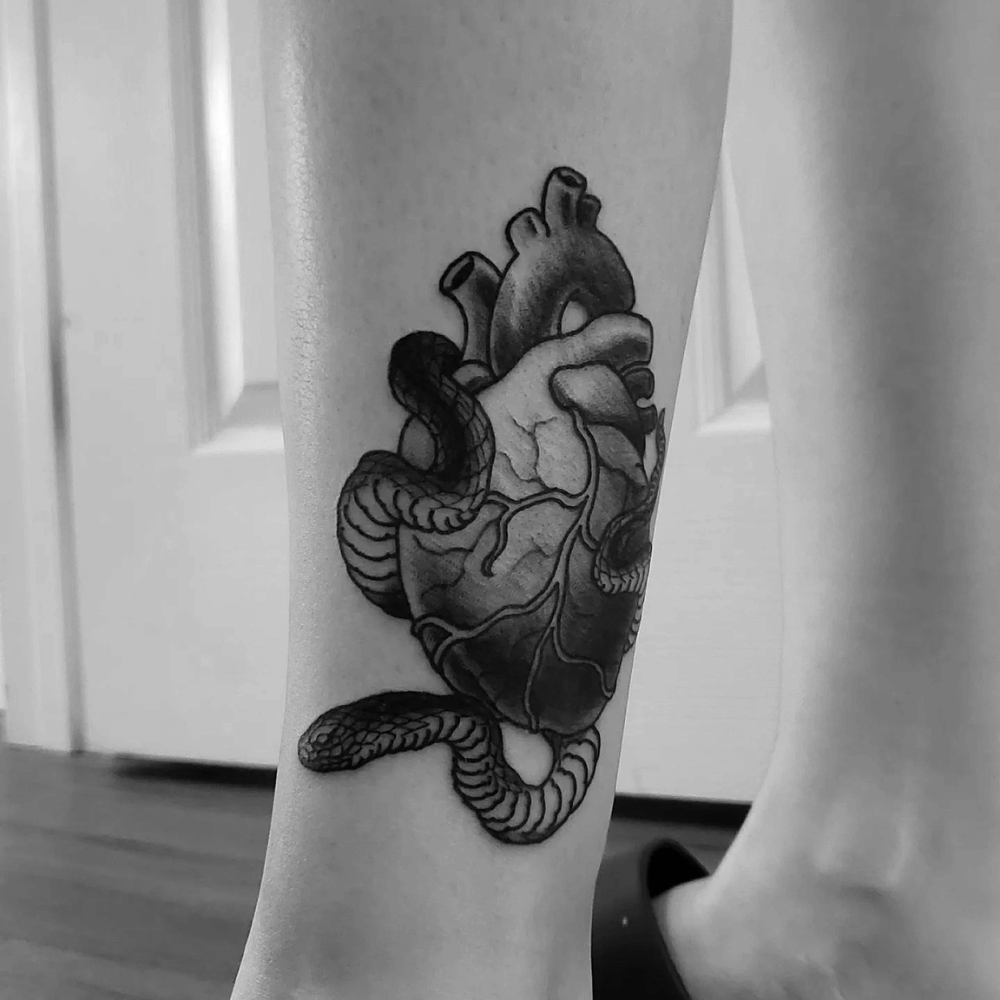 Snake Heart Tattoo Source @dark.matter.tattoo.studio via Instagram