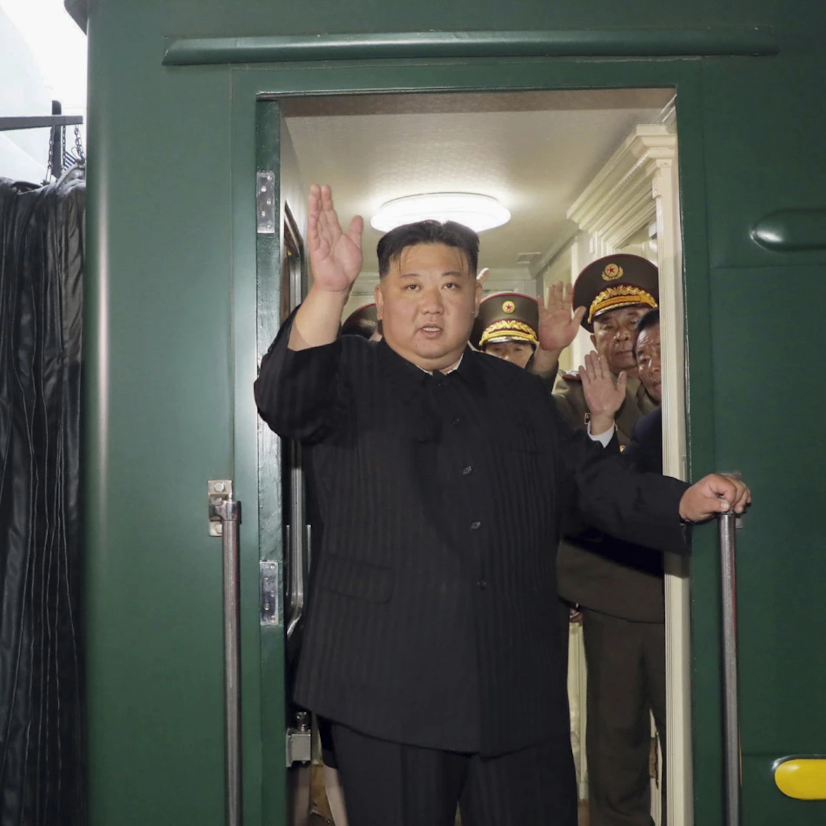 Kim Jong Un waving from his train