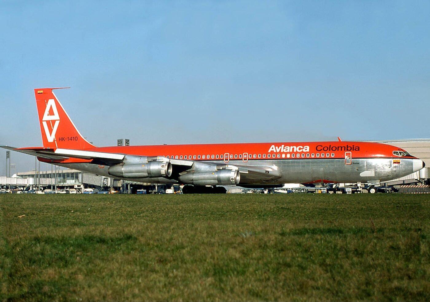 An Avianca Boeing 777 in orange and silver. 